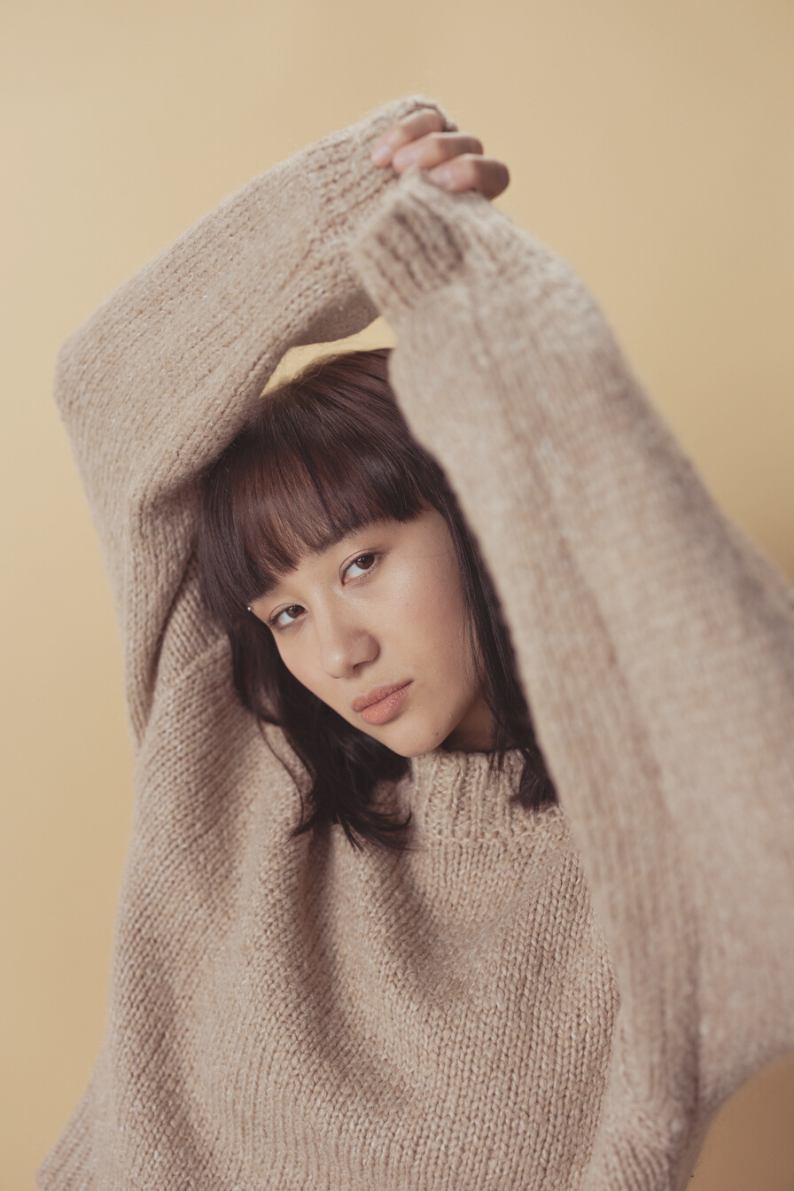 A Woman in Beige Knit Sweater